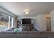 Living room showcases a comfortable gray couch, media center, and natural light from a large window at 9703 Ogden Ct, Thornton, CO 80229