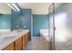 Main bathroom with double vanity, separate shower and tub, offering relaxation and convenience at 9703 Ogden Ct, Thornton, CO 80229