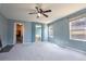 Spacious main bedroom featuring plush carpet, ceiling fan, and ensuite bathroom at 9703 Ogden Ct, Thornton, CO 80229