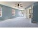 Large main bedroom with ceiling fan and natural light, leading into an ensuite bath at 9703 Ogden Ct, Thornton, CO 80229