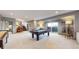 Spacious basement featuring a pool table, carpeted floors, and access to an outdoor patio at 11194 W Yucca, Littleton, CO 80125