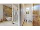 Luxurious bathroom featuring a walk-in glass shower and a soaking tub with stone accent wall at 11194 W Yucca, Littleton, CO 80125