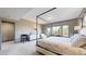 Open bedroom with large windows, a canopy bed, and a dedicated desk area, perfect for reading at 11194 W Yucca, Littleton, CO 80125