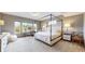 Bright bedroom with large windows, a canopy bed, and a dedicated desk area, perfect for working at 11194 W Yucca, Littleton, CO 80125