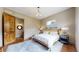 Bright bedroom boasts wooden door, hardwood floors, and a cozy rug underneath the bed for added comfort at 11194 W Yucca, Littleton, CO 80125