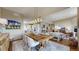 Spacious dining room with rustic wood table and art, open to living room and kitchen at 11194 W Yucca, Littleton, CO 80125