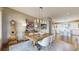 Stylish dining room with a rustic table, upholstered chairs, and hardwood floors, open to the kitchen at 11194 W Yucca, Littleton, CO 80125