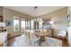 Elegant dining room featuring a rustic wooden table, stylish chairs, and a chic modern chandelier at 11194 W Yucca, Littleton, CO 80125
