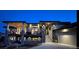 Beautiful home with stone accents, covered decks, and lush landscaping, illuminated by elegant outdoor lighting at 11194 W Yucca, Littleton, CO 80125