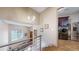 Hallway with wood stairs, metal railings, and laundry room featuring stainless steel appliances at 11194 W Yucca, Littleton, CO 80125