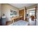 Home office with vintage desk, with view through French doors to a modern living space at 11194 W Yucca, Littleton, CO 80125