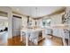 Bright kitchen with sleek appliances, white cabinetry, and a center island with barstool seating at 11194 W Yucca, Littleton, CO 80125