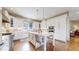 Modern white kitchen with stainless steel appliances and a center island with seating at 11194 W Yucca, Littleton, CO 80125