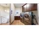 Functional laundry room with washer, dryer, sink, storage cabinets, and modern finishes at 11194 W Yucca, Littleton, CO 80125