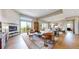 Spacious open-concept living room with fireplace, hardwood floors, and access to outdoor balcony at 11194 W Yucca, Littleton, CO 80125