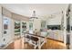 Dining room with hardwood floors, modern light fixture, and sliding glass doors leading to the backyard at 10068 Granite Hill Dr, Parker, CO 80134