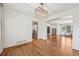 Open-concept dining area with hardwood floors leads to a bright living room and modern kitchen at 10068 Granite Hill Dr, Parker, CO 80134