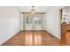 Empty dining room boasts hardwood floors, natural light, and elegant chandelier ready for personalized decor at 10068 Granite Hill Dr, Parker, CO 80134
