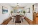 Elegant dining room featuring modern chandelier, hardwood floors, and large windows for abundant natural light at 10068 Granite Hill Dr, Parker, CO 80134