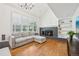 Bright living room with hardwood floors, fireplace, built-in shelving, large windows, and vaulted ceiling at 10068 Granite Hill Dr, Parker, CO 80134