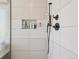 Modern shower with stylish tile, convenient built-in shelf, and sleek fixtures for a spa-like experience at 10068 Granite Hill Dr, Parker, CO 80134