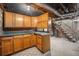 Unfinished basement space featuring brickwork, stairs, concrete floors and wood cabinets at 1021 E 23Rd Ave, Denver, CO 80205