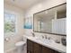 Bathroom featuring a modern vanity, a large mirror and a combined shower and tub at 1021 E 23Rd Ave, Denver, CO 80205