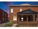Charming brick home featuring a cozy front porch and well-maintained landscaping at 1021 E 23Rd Ave, Denver, CO 80205
