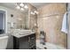 Well-lit bathroom features a vessel sink, stone tiled shower, and modern fixtures at 1150 Vine St # 1006, Denver, CO 80206