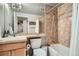 Bathroom featuring a shower-tub combination with tiled walls, updated vanity and decor at 1150 Vine St # 1006, Denver, CO 80206