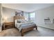 Cozy bedroom featuring a wooden bed frame, soft carpet, and ample natural light from the window at 1150 Vine St # 1006, Denver, CO 80206