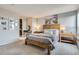Spacious bedroom featuring a wooden bed frame, art, and closet with built-in storage at 1150 Vine St # 1006, Denver, CO 80206