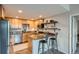 Modern kitchen with stainless steel appliances, granite countertops, and wood cabinets at 1150 Vine St # 1006, Denver, CO 80206
