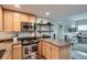 Modern kitchen with stainless steel appliances, granite countertops, and wood cabinets at 1150 Vine St # 1006, Denver, CO 80206