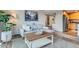 Cozy living room featuring a gray sectional couch, stylish decor, and an open view to the kitchen at 1150 Vine St # 1006, Denver, CO 80206