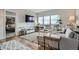 Bright living room with modern furniture, hardwood floors, and access to a balcony with great city views at 1150 Vine St # 1006, Denver, CO 80206