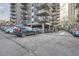 Outdoor parking area with ample spaces available and building in the background at 1150 Vine St # 1006, Denver, CO 80206