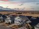 Stunning aerial view of suburban houses with picturesque scenery and sunset sky, mountains in the background at 7895 Julsburg Cir, Littleton, CO 80125