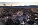 Aerial view of a suburban neighborhood at dusk showing the well-lit streets and homes at 7895 Julsburg Cir, Littleton, CO 80125