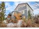 Backyard view showcases a spacious deck, outdoor seating, and lush landscaping at 7895 Julsburg Cir, Littleton, CO 80125