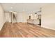 Open basement area with wood floors, carpeted stairs, and seating at 7895 Julsburg Cir, Littleton, CO 80125