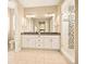 Well-lit bathroom featuring double vanity with granite countertops and a modern glass shower with tile accents at 7895 Julsburg Cir, Littleton, CO 80125