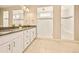 Modern bathroom with dual sinks, granite counters, and a glass-enclosed shower for a spa-like experience at 7895 Julsburg Cir, Littleton, CO 80125