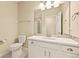 Well-lit bathroom with a single sink vanity, mirror, and a toilet at 7895 Julsburg Cir, Littleton, CO 80125
