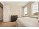 Bright bedroom with neutral walls, plush carpet and natural light from the two windows at 7895 Julsburg Cir, Littleton, CO 80125