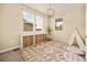 Bright bedroom featuring a patterned rug, stylish light fixture, and storage shelves at 7895 Julsburg Cir, Littleton, CO 80125