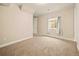 Neutral bedroom with carpet and white trim, bright window, and minimalist design at 7895 Julsburg Cir, Littleton, CO 80125