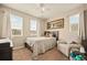 Cozy bedroom featuring plush carpet, a ceiling fan, and light-filled windows at 7895 Julsburg Cir, Littleton, CO 80125