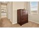 Cozy bedroom featuring carpet, a window and a dresser, providing comfort and functionality at 7895 Julsburg Cir, Littleton, CO 80125
