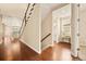 Foyer shows hardwood floors, a staircase with white risers and a glimpse into the dining area, as well as an alcove at 7895 Julsburg Cir, Littleton, CO 80125